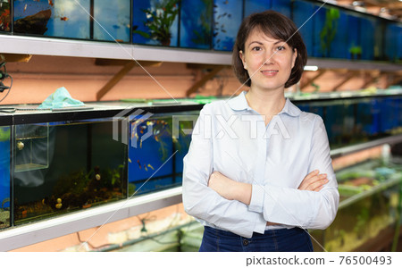 Confident woman near fish tanks Confident woman near fish tanks 76500493