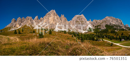 Panoramic view of magical Dolomite peaks of Pizes da Cir, Passo Gardena in Autumn colors during sunset at blue sky, South Tyrol, Italy Panoramic view of magical Dolomite peaks of Pizes da Cir, Passo Gardena in Autumn colors during sunset at blue sky, South Tyrol, Italy 76501351