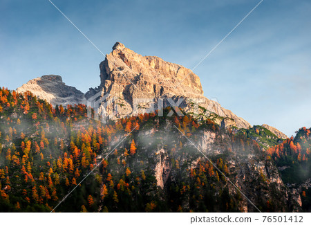 Panoramic view of magical Dolomite peaks at the national park Three Peaks (Tre Cime, Drei Zinnen) in Autumn October colors during sunset at blue sky, South Tyrol, Italy 76501412