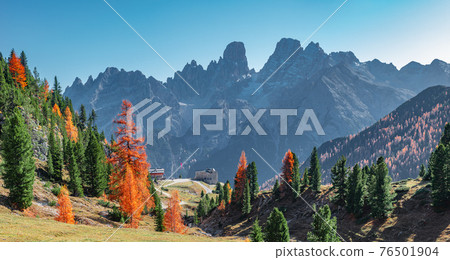 Panoramic view of magical Dolomite peaks at the national park Three Peaks (Tre Cime, Drei Zinnen) and mountain hut in Autumn colors during sunset backlit at blue sky, South Tyrol, Italy, golden season Panoramic view of magical Dolomite peaks at the national park Three Peaks (Tre Cime, Drei Zinnen) and mountain hut in Autumn colors during sunset backlit at blue sky, South Tyrol, Italy, golden season 76501904