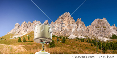 Panoramic view of magical Dolomite peaks of Pizes da Cir, Passo Gardena and travel cooking gears at blue sky, South Tyrol, Italy, details 76501906