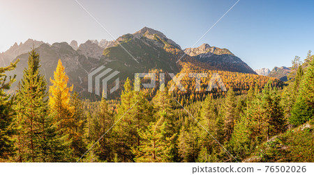 Panoramic view of magical nature in Dolomites at the national park Three Peaks (Tre Cime, Drei Zinnen) during sunset at direct light, South Tyrol, Italy, wide angle 76502026