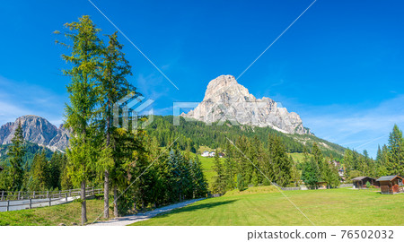Panoramic view of magical Dolomite peak Sassongher, forests, valleys at sunny day and blue sky, Colfosco, Corvara, South Tyrol, Italy, wide angle Panoramic view of magical Dolomite peak Sassongher, forests, valleys at sunny day and blue sky, Colfosco, Corvara, South Tyrol, Italy, wide angle 76502032