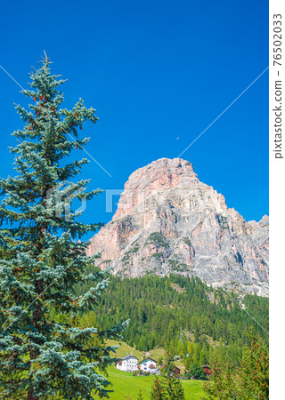 Magical Dolomite peak Sassongher, forests, valleys at sunny day and blue sky, Colfosco, Corvara, South Tyrol, Italy, closeup, details 76502033