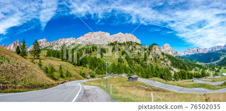 Panoramic view made from Passo Gardena of magical Dolomite peaks of Cima Cunturines and serpentine mountain road, South Tyrol, Italy, wide angle Panoramic view made from Passo Gardena of magical Dolomite peaks of Cima Cunturines and serpentine mountain road, South Tyrol, Italy, wide angle 76502035