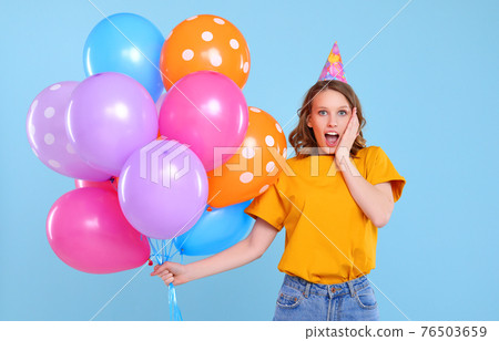 Surprised woman with party balloons Surprised woman with party balloons 76503659