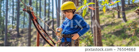 BANNER, LONG FORMAT Happy child in a helmet, healthy teenager school boy enjoying activity in a climbing adventure park on a summer day BANNER, LONG FORMAT Happy child in a helmet, healthy teenager school boy enjoying activity in a climbing adventure park on a summer day 76504668