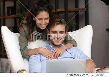 Close up happy young family using laptop together, shopping online Close up happy young family using laptop together, shopping online 76504850