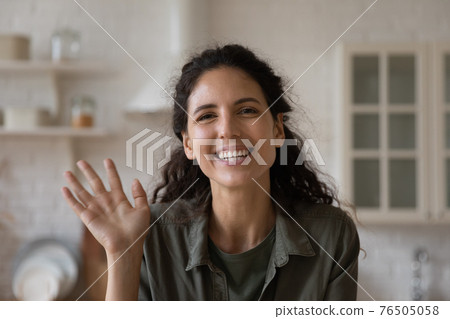 Head shot portrait smiling woman waving hand, making video call 76505058