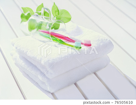 Towel and two toothbrushes 76505610