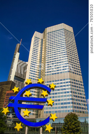 Symbol of Euro currency in front of skyscraper in financial downtown of Frankfurt, Germany, Symbol of Euro currency in front of skyscraper in financial downtown of Frankfurt, Germany, 76505810
