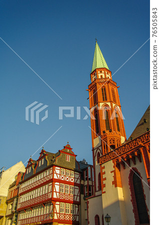 Traditional German old half-timbered houses (fachwerk) at historical downtown in Frankfurt, Germany, during colorful sunset, cityscape 76505843