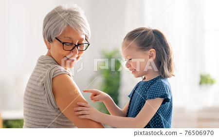 Senior woman after vaccination. 76506970