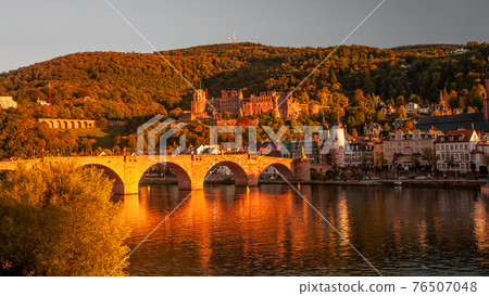 Panoramic view during red sunset at old bridge, downtown and castle in Heidelberg, Germany Panoramic view during red sunset at old bridge, downtown and castle in Heidelberg, Germany 76507048
