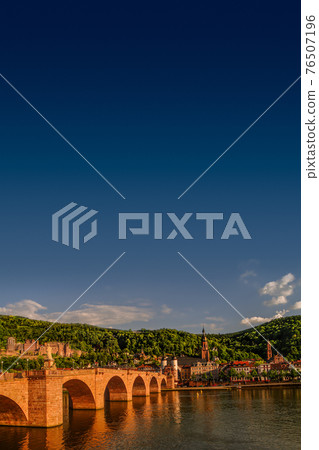 Colorful view of old downtown in Heidelberg, old bridge, statues and ancient castle during sunset, Heidelberg, Germany Colorful view of old downtown in Heidelberg, old bridge, statues and ancient castle during sunset, Heidelberg, Germany 76507196
