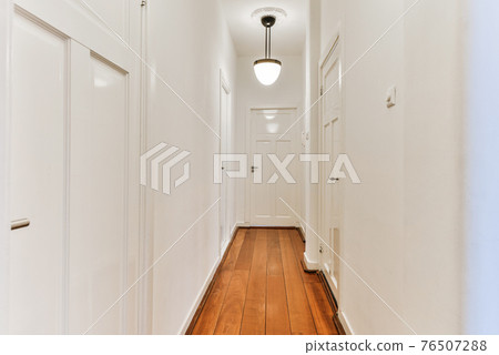 Narrow corridor with doors and lamp Narrow corridor with doors and lamp 76507288
