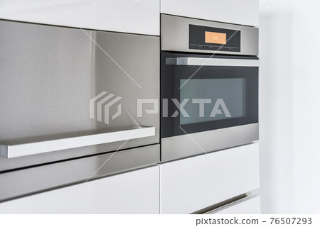 Modern oven and cabinets in kitchen Modern oven and cabinets in kitchen 76507293