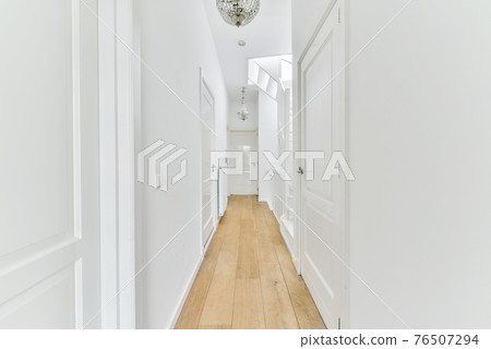 Narrow corridor with doors and lamp Narrow corridor with doors and lamp 76507294
