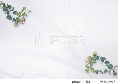 Frame of dried flowers placed on white fabric 76508697