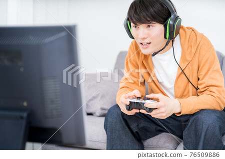 A man playing a net game in the room 76509886