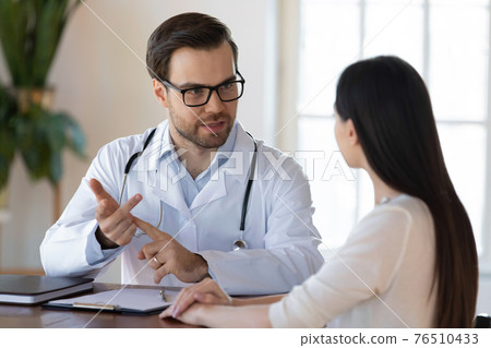 Male doctor consult female patient in hospital Male doctor consult female patient in hospital 76510433