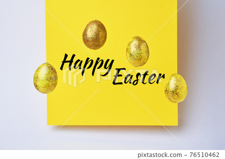 Golden shiny eggs and yellow blank with text - Happy Easter. Golden shiny eggs and yellow blank with text - Happy Easter. 76510462