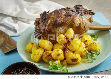 Baked pork shoulder with potato Baked pork shoulder with potato 76510532