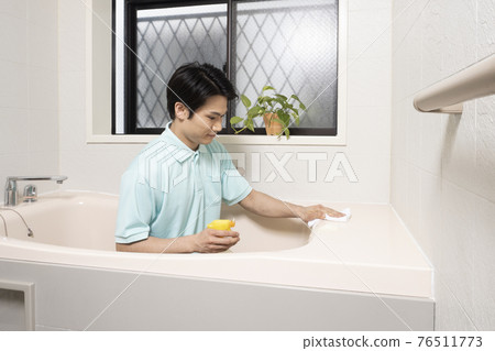 House cleaning male worker cleaning the bathroom House cleaning male worker cleaning the bathroom 76511773