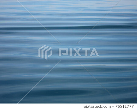 Sea in background with small ripples Sea in background with small ripples 76511777