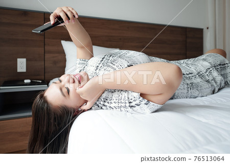 Woman videocalling friend Woman videocalling friend 76513064