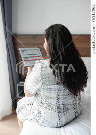 Woman booking ticket online Woman booking ticket online 76513066