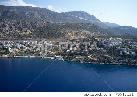 Aerial panoramic view of coastal town and mountains. Aerial panoramic view of coastal town and mountains. 76513131