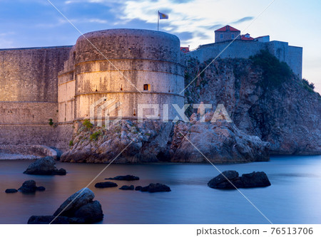 Dubrovnik. Old stone city walls and towers at sunset. Dubrovnik. Old stone city walls and towers at sunset. 76513706