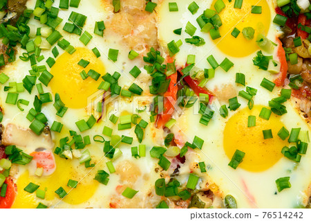 baked mixed vegetables and eggs close view, baking tray with tomatoes, broccoli and spices, home cooking 76514242