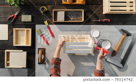 Top view of unrecognizable woman making wooden boxes, small business and desktop concept. 76514742