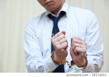 A male office worker arrested for committing a crime A male office worker arrested for committing a crime 76514831