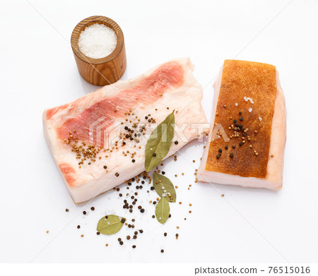 raw lard two pieces and salt, spices and bay leaf on white background, pork fat raw lard two pieces and salt, spices and bay leaf on white background, pork fat 76515016