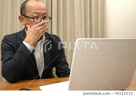 Middle-aged man working from home 76515213