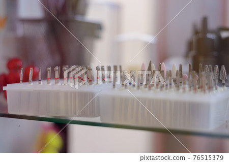 counter with goods for nail service, nozzles for hardware manicure 76515379