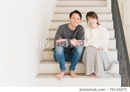Young couple relaxing in their own home Young couple relaxing in their own home 76516073