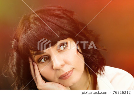 Beautiful brunette with short hair close-up. blue background Beautiful brunette with short hair close-up. blue background 76516212