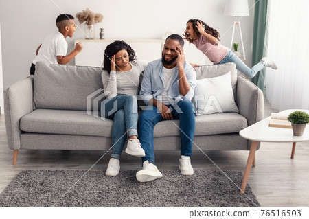 Noisy black children fighting over their shocked parents Noisy black children fighting over their shocked parents 76516503
