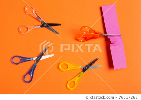 minimal leadership concept, four colored scissors on an orange background, scissors cut paper, business minimal leadership concept, four colored scissors on an orange background, scissors cut paper, business 76517263