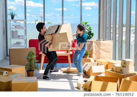 young asian couple smiling and enjoy when they carrying big cardboard box while relocation into new home on moving day, celebrating moving to new home concept young asian couple smiling and enjoy when they carrying big cardboard box while relocation into new home on moving day, celebrating moving to new home concept 76519052