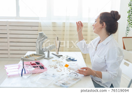 Professional accessories designer making handmade jewelry in studio workshop. Fashion, creativity and handmade concept. Professional accessories designer making handmade jewelry in studio workshop. Fashion, creativity and handmade concept. 76519094