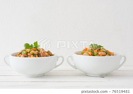 Healthy grain salad in bowl on wooden table 76519481