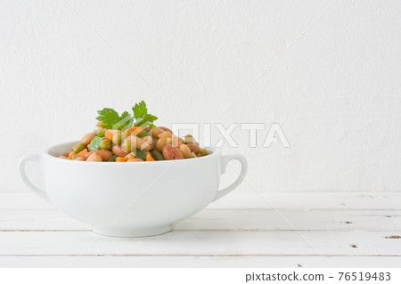 Healthy grain salad in bowl on wooden table 76519483