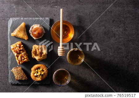 Assortment of Ramadan dessert baklava on black background 76519517
