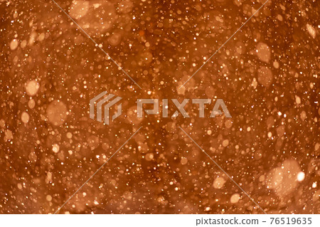 Beautiful blurry sparkles on orange background. Liquid soap in bottle close up 76519635