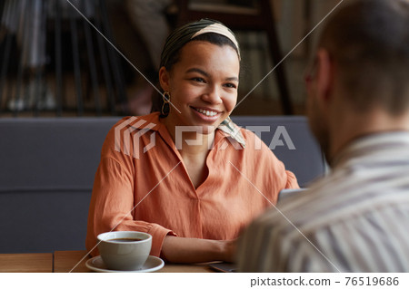 Smiling Woman at Business Meting in Cafe 76519686
